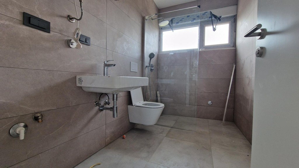 Salle de bains avec lavabo, WC suspendu et douche à l'italienne