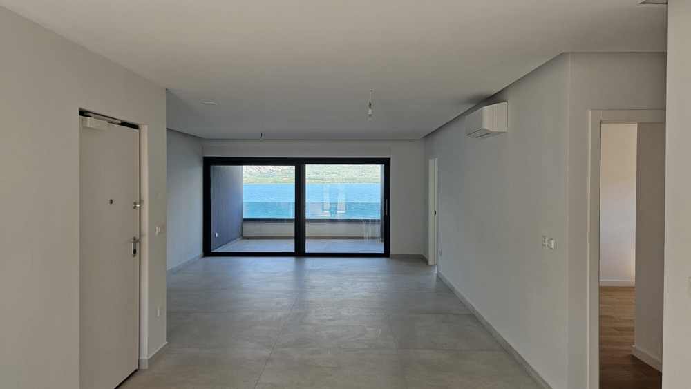 Salon dans l'immeuble neuf moderne en première ligne sur la mer avec une superbe vue mer.