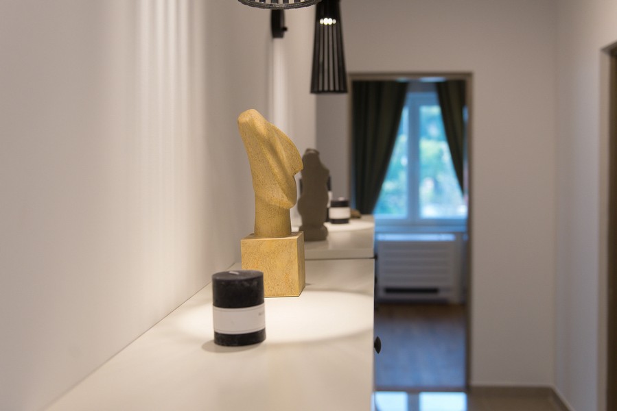 Buffet avec sculpture dans le couloir devant la pièce lumineuse