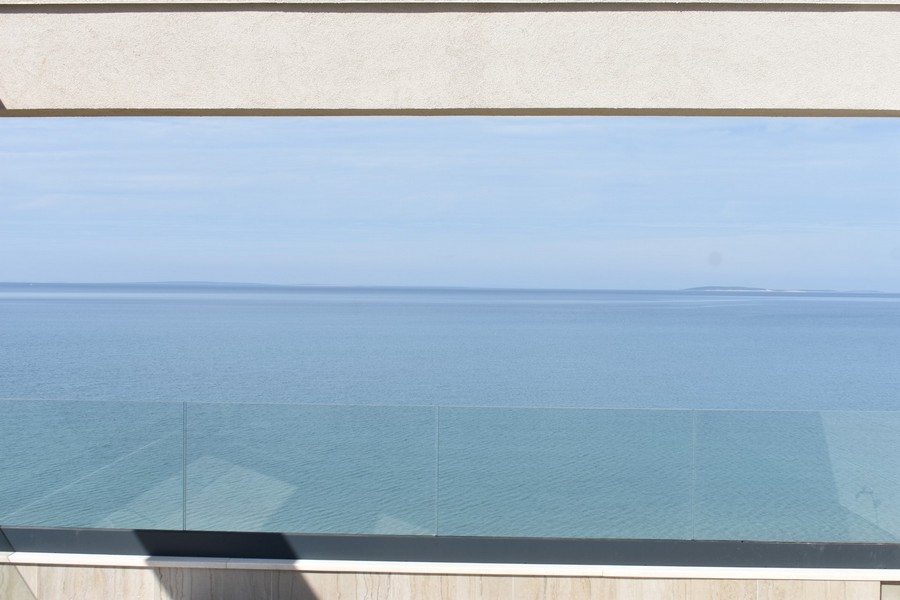 Mer calme derrière le garde-corps en verre de la terrasse