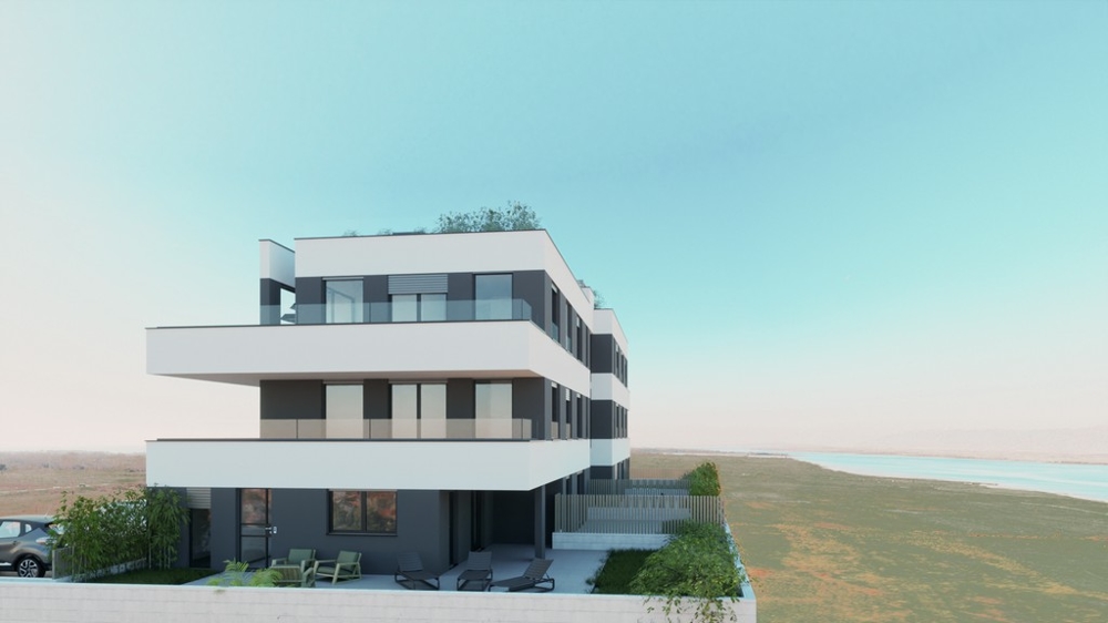 Immeuble neuf avec terrasses au rez-de-chaussée et de l'eau à l'arrière-plan