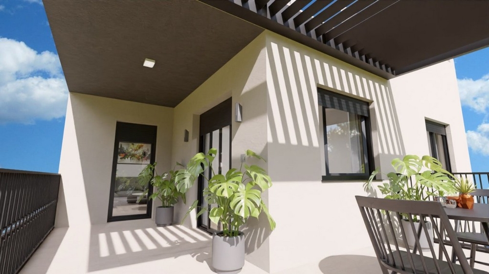Balcon couvert avec plantes et sièges, accessible depuis l'appartement.