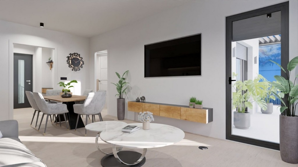 Salon moderne avec coin repas, télévision et accès au balcon avec vue mer.