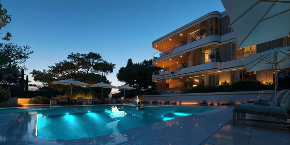 Visualisation de la piscine éclairée devant la résidence le soir