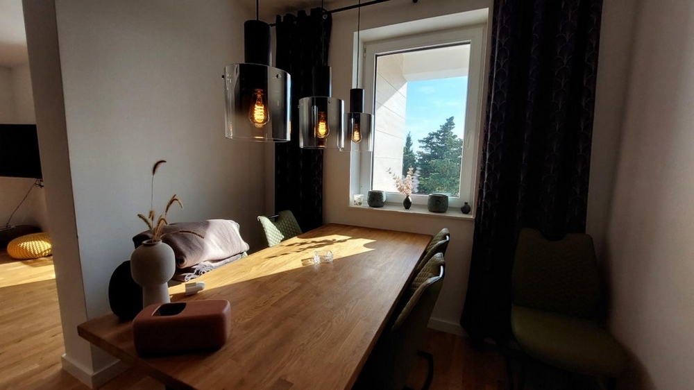 Table à manger en bois avec suspensions à la fenêtre