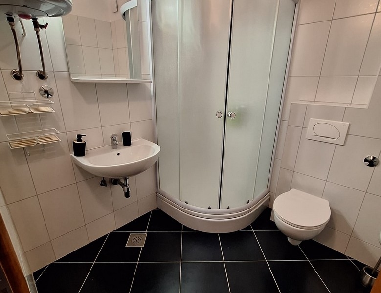 Salle de bains moderne avec cabine de douche, lavabo et WC