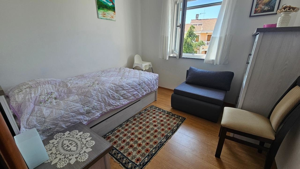 Chambre avec lit simple et fauteuil