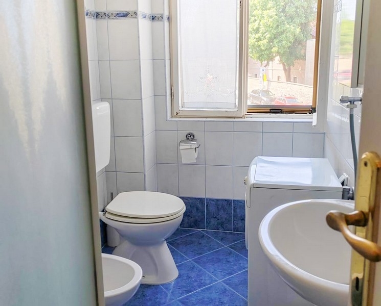 Salle de bains avec fenêtre et carrelage bleu