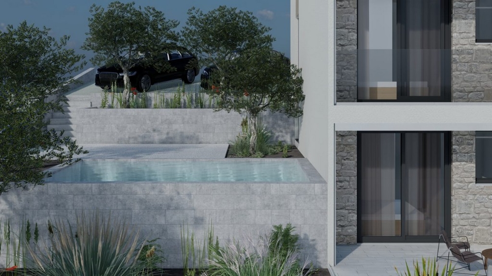 Piscine devant le bâtiment avec végétation et places de stationnement