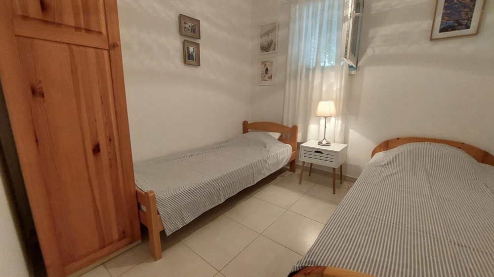 Deuxième chambre avec deux lits simples et armoire