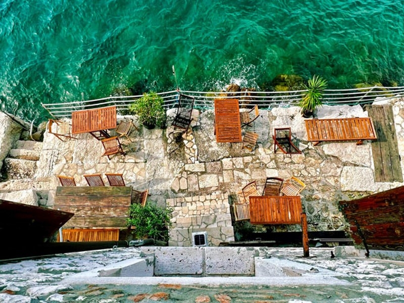 Passerelles en bois et plateformes de baignade au-dessus de l'eau turquoise