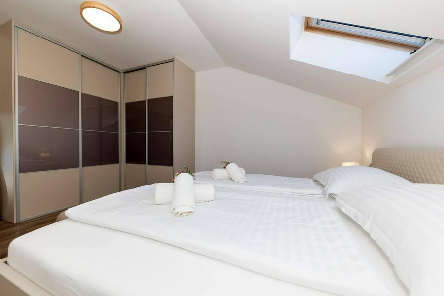 Chambre avec fenêtre de toit et grande armoire