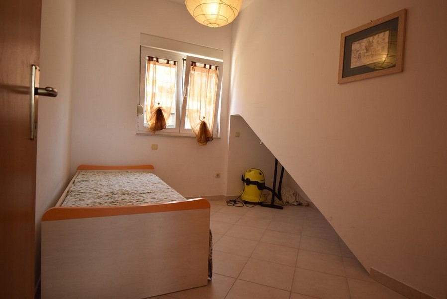 Petite chambre avec lit simple et mur en pente