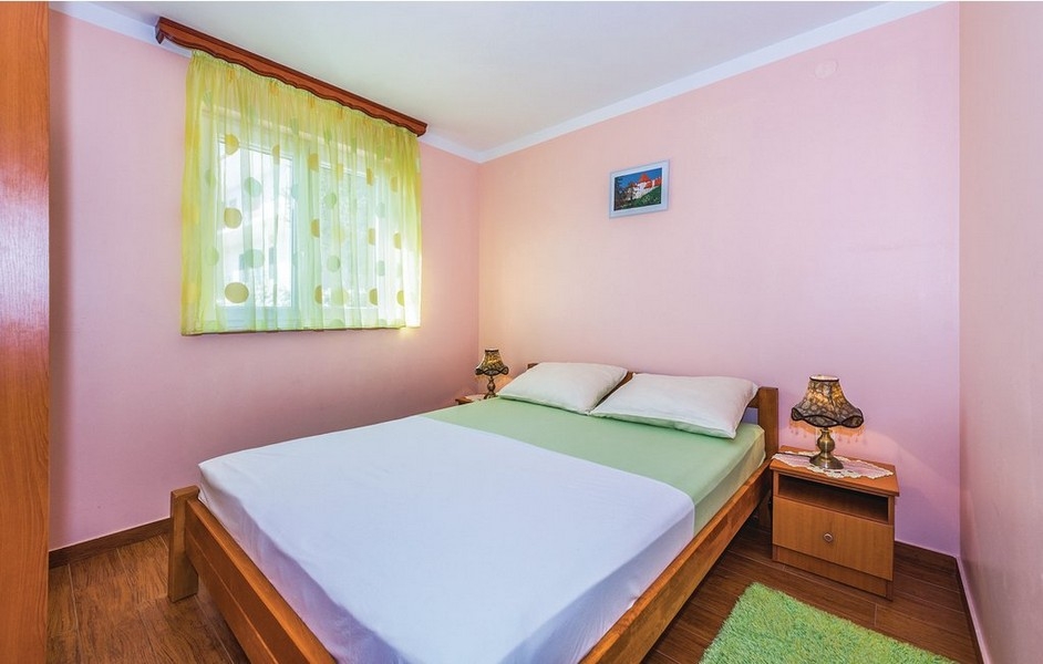 Chambre rose avec rideau jaune à la fenêtre
