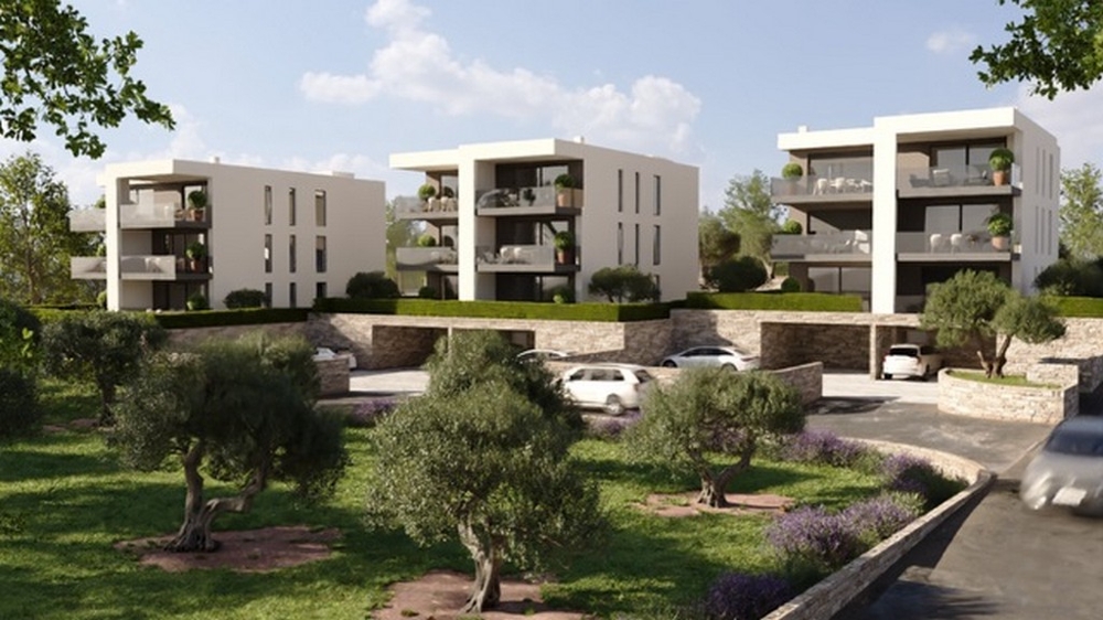 Visualisation de trois immeubles d'habitation au-dessus de murs en pierre sèche et d'oliviers