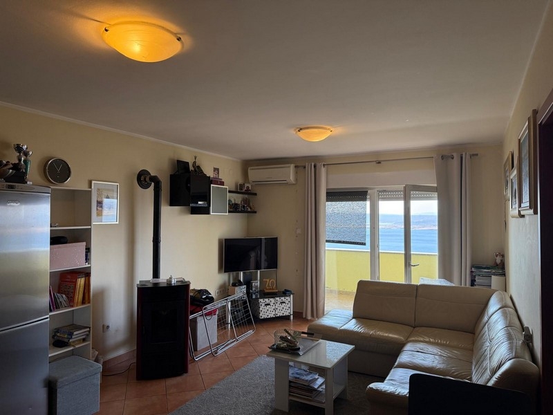 Salon avec coin TV et accès au balcon