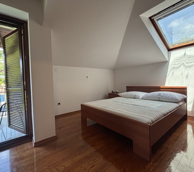 Chambre avec accès au balcon et fenêtre de toit