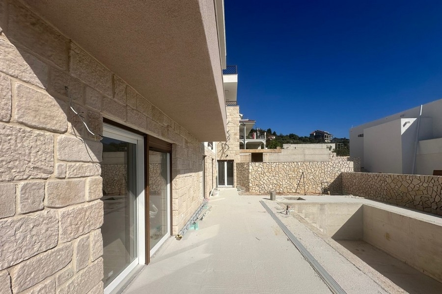 Terrasse avec façade en pierre naturelle et espace piscine