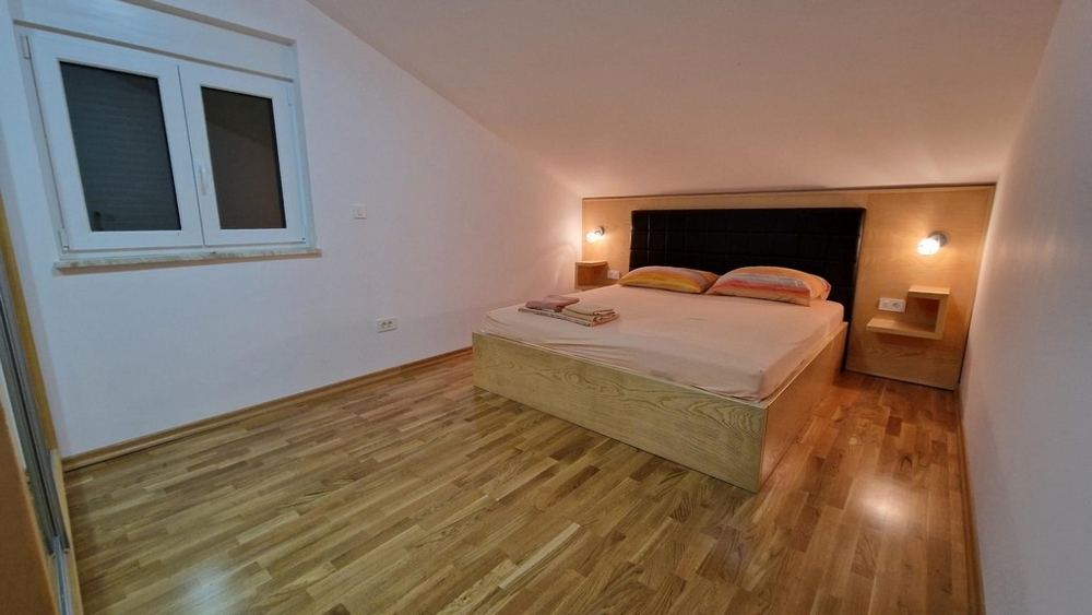 Chambre avec lit double et parquet à Njivice sur Krk