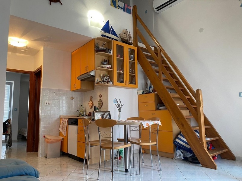 Séjour avec escalier vers la mezzanine et coin salon