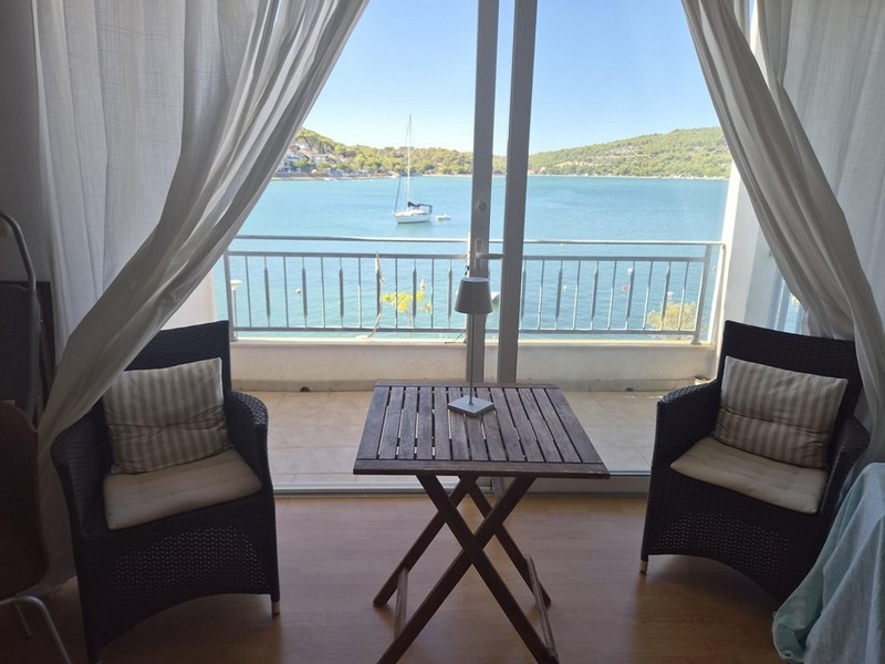 Pièce de vie avec portes vitrées donnant sur la loggia et vue sur la mer
