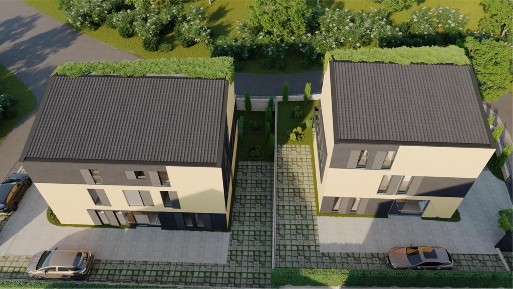 Vue aérienne de deux bâtiments avec toits végétalisés et places de stationnement