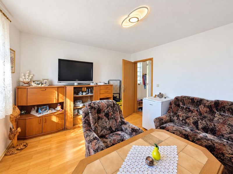Salon avec téléviseur et parquet