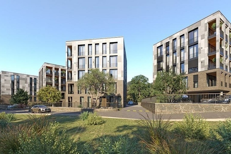 Immeuble résidentiel avec balcons entre les oliviers