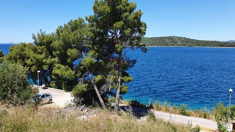 Pin au bord de l'eau avec parking et vue sur l'île