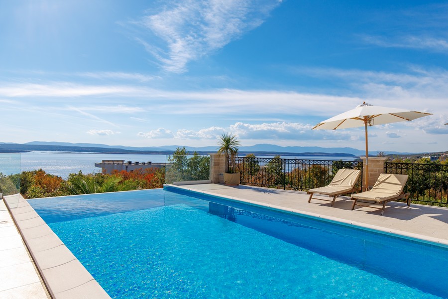 Piscine à débordement avec transats au-dessus de la baie de Crikvenica