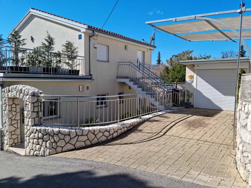 Cour avec carport et accès pavé à la maison