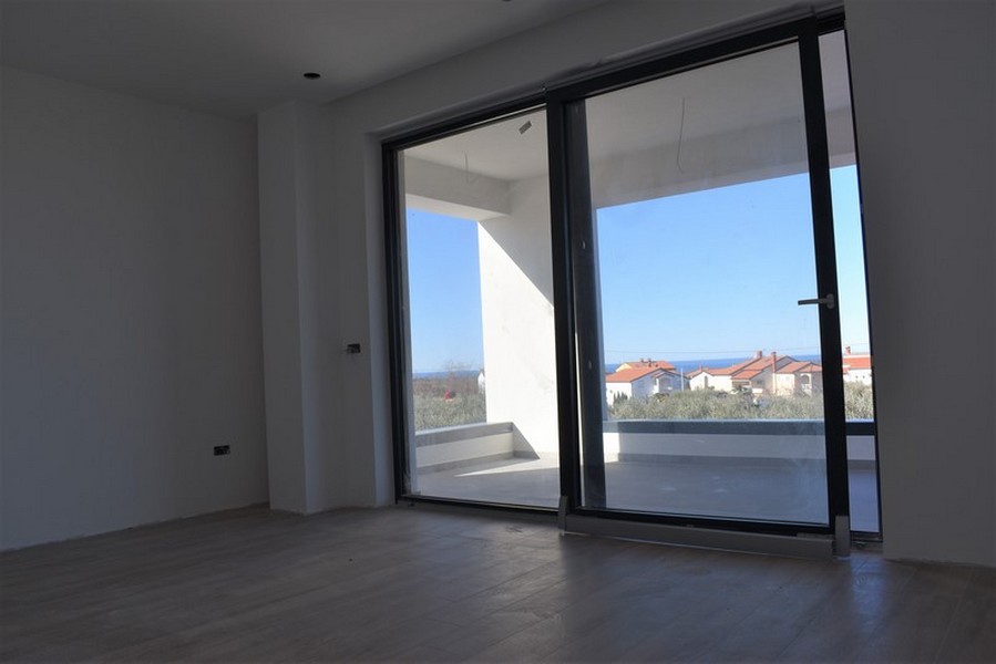 Pièce avec large porte coulissante donnant sur la terrasse et vue dégagée
