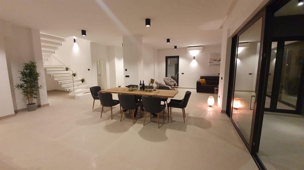 Espace ouvert avec table à manger et vue sur la cage d'escalier.