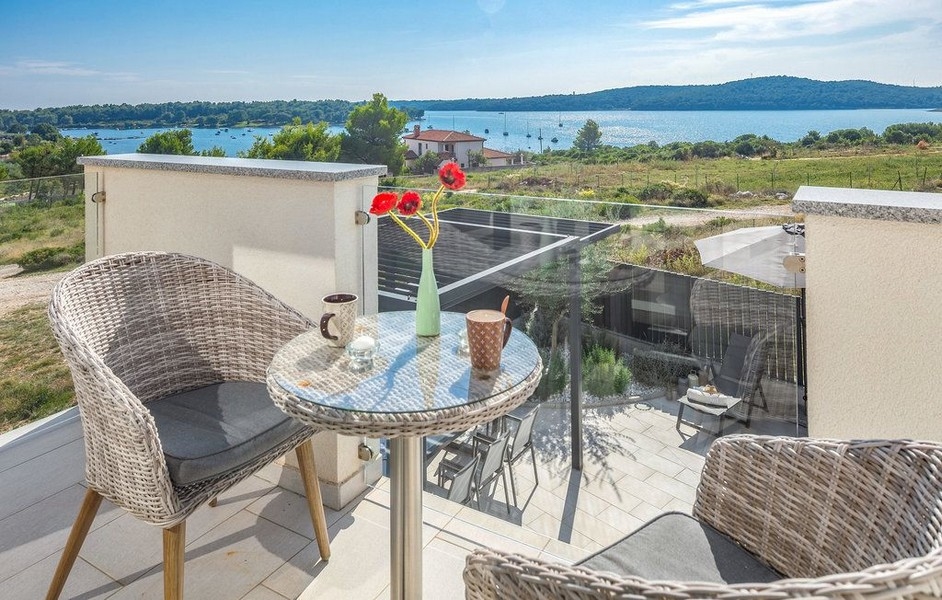 Table de bistrot sur le balcon avec vue sur la baie de Medulin