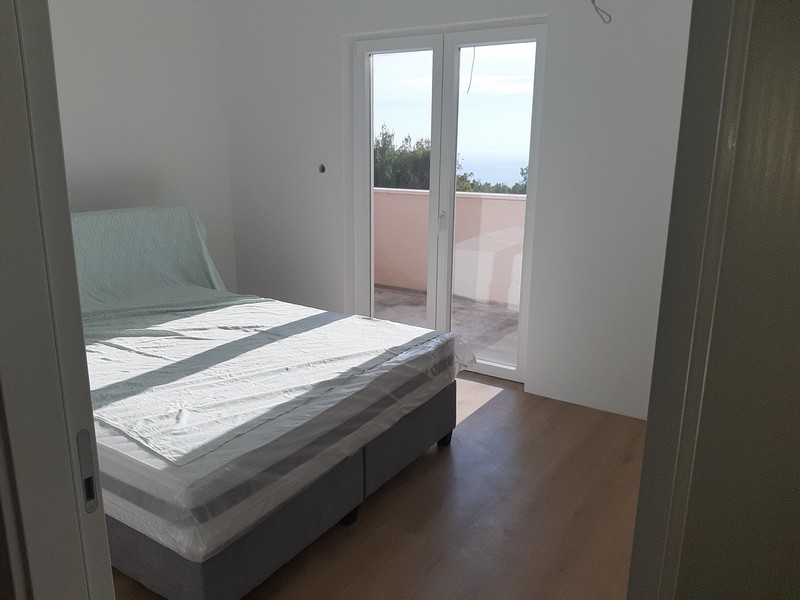 Chambre avec lit et porte donnant sur le balcon