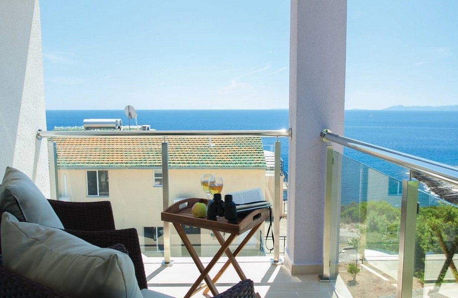 Balcon avec plateau sur la table pliante et vue sur la mer