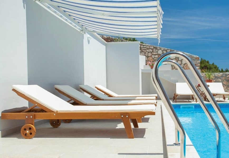 Bains de soleil haut de gamme au bord de la piscine.