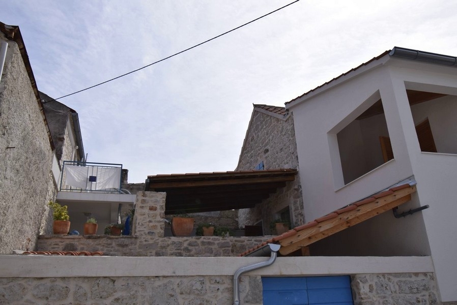 Maisons en pierre avec pots de fleurs sur le mur de la terrasse