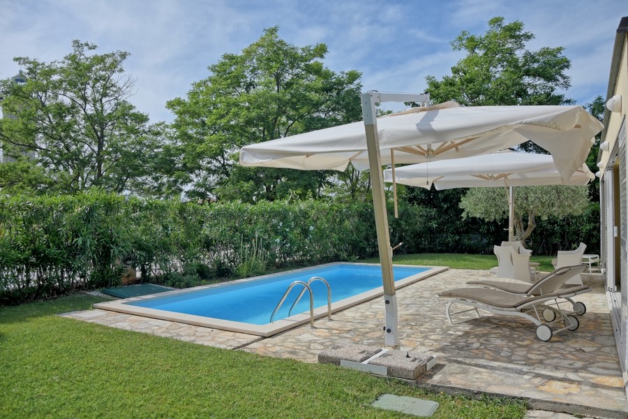 Maison à vendre en Istrie, avec piscine privée et vue sur une verdure luxuriante.
