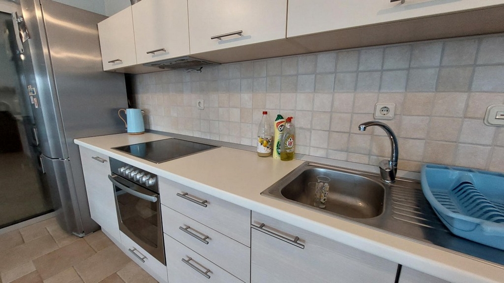 Cuisine moderne avec cuisinière, évier et réfrigérateur dans une maison en Croatie