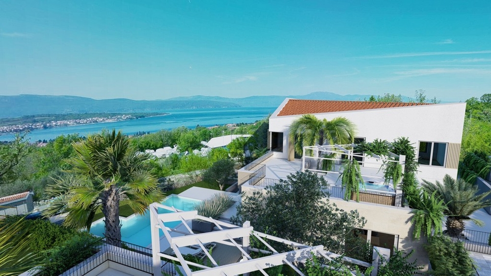 Maison blanche avec palmiers et piscine au-dessus de la vaste baie