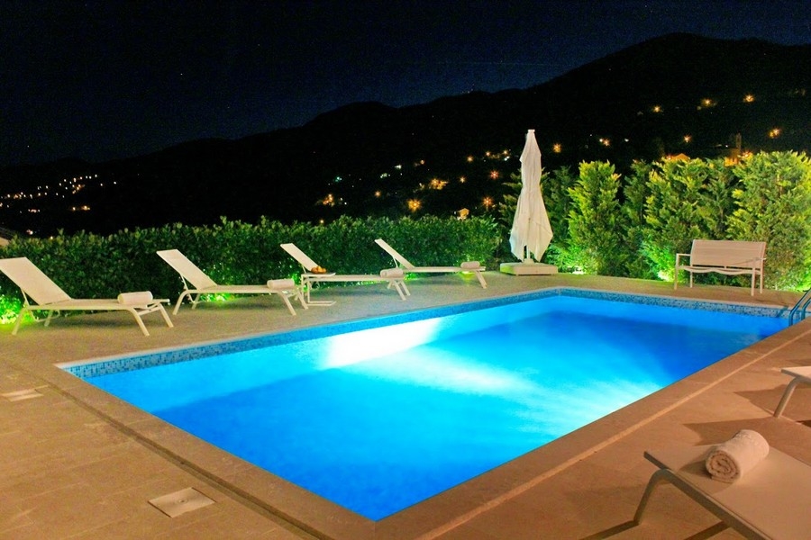 Piscine de nuit avec éclairage et vue