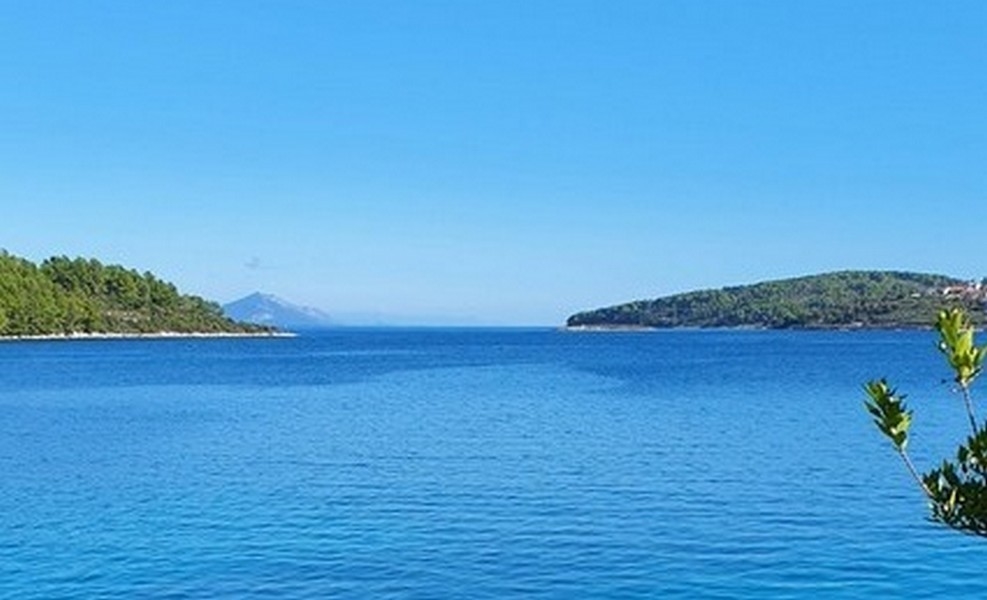 Mer calme entre deux pointes boisées