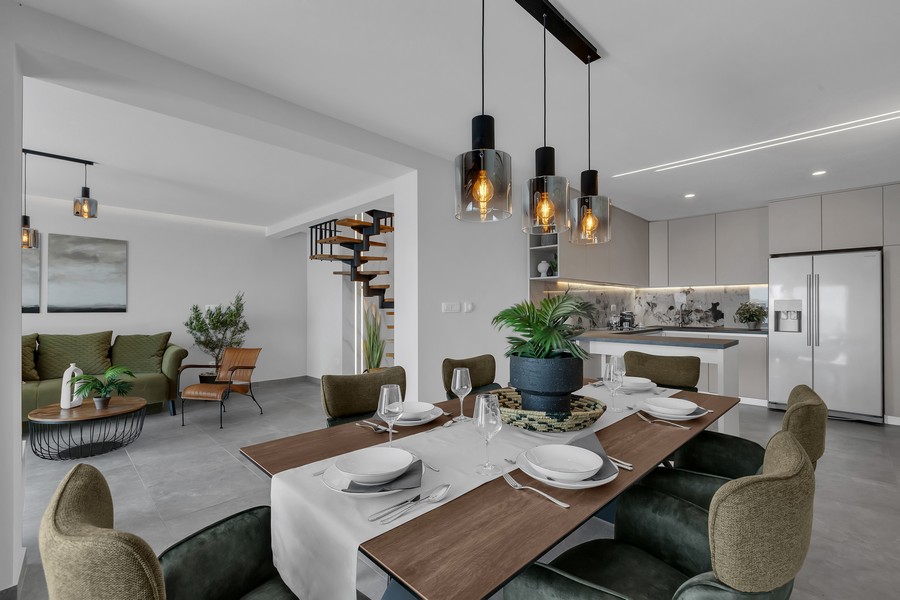 Coin repas au design élégant à côté de la cuisine