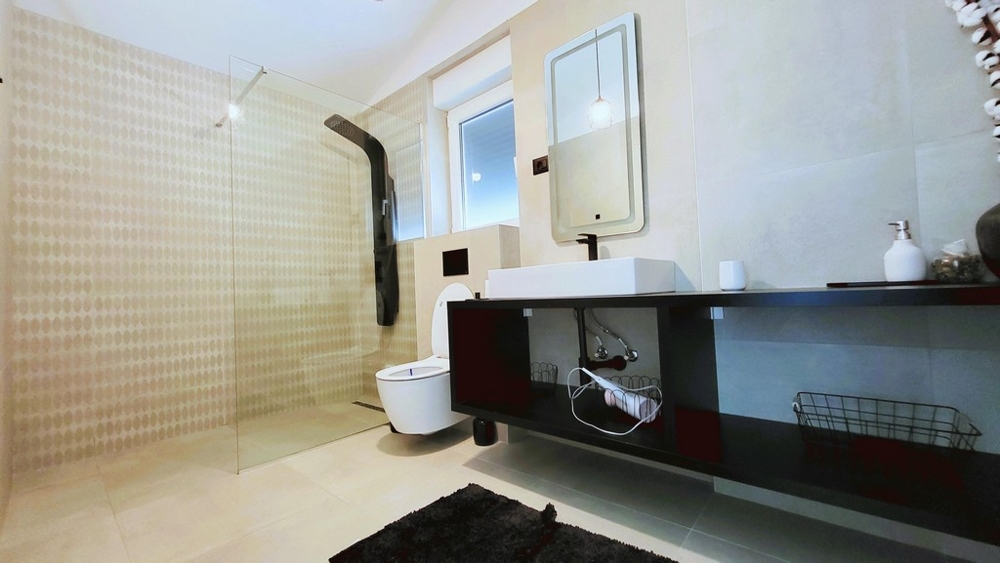 Salle de bains avec douche à l'italienne et meuble-lavabo moderne