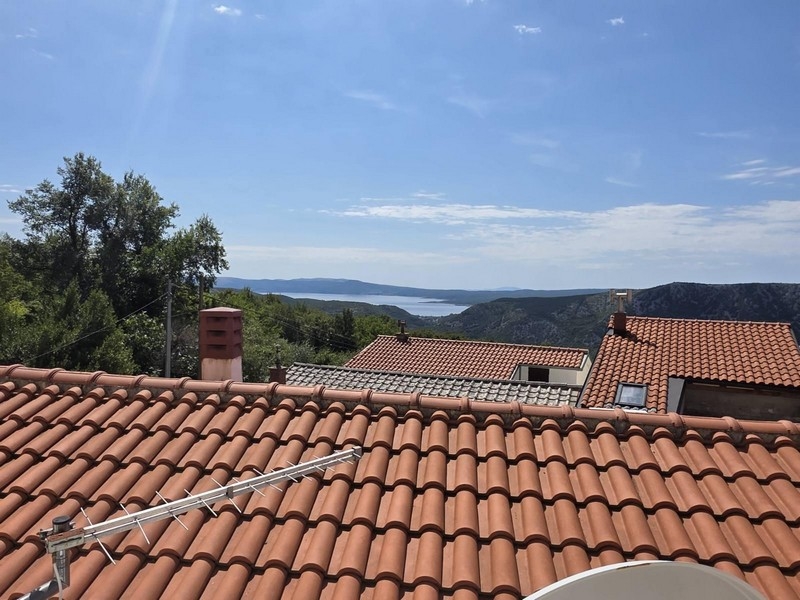 Vue du toit-terrasse par-dessus les toits de tuiles sur la mer