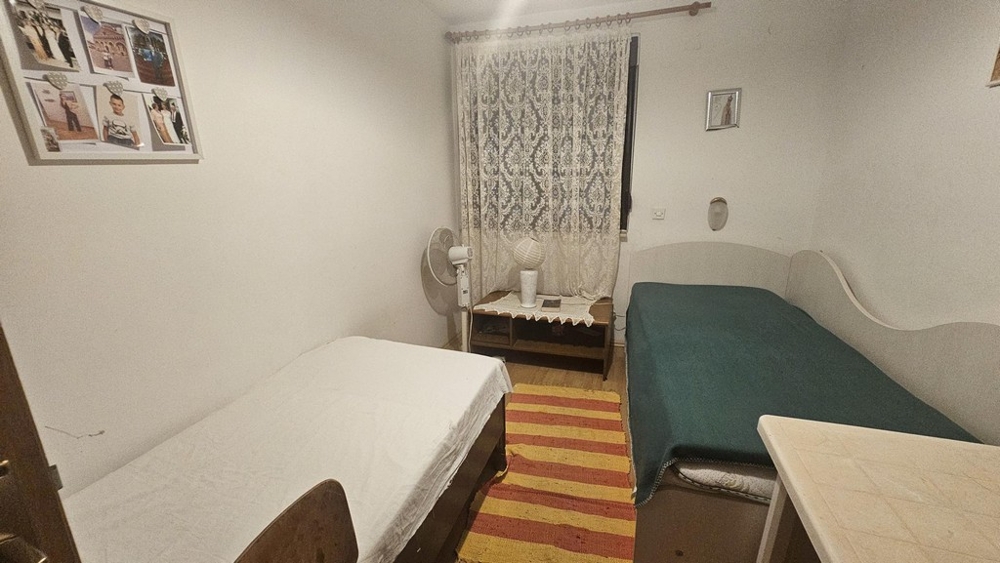 Chambre avec deux lits simples et fenêtre
