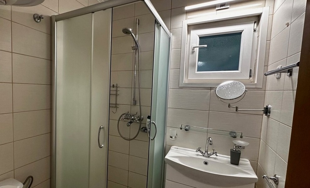 Salle de bains avec douche et lavabo