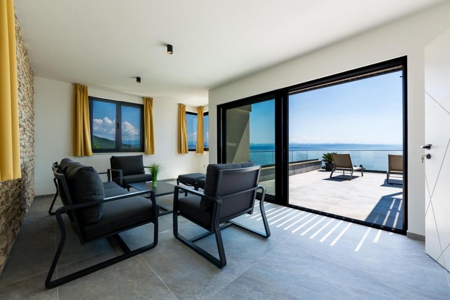 Espace lounge avec accès à la terrasse et vue mer