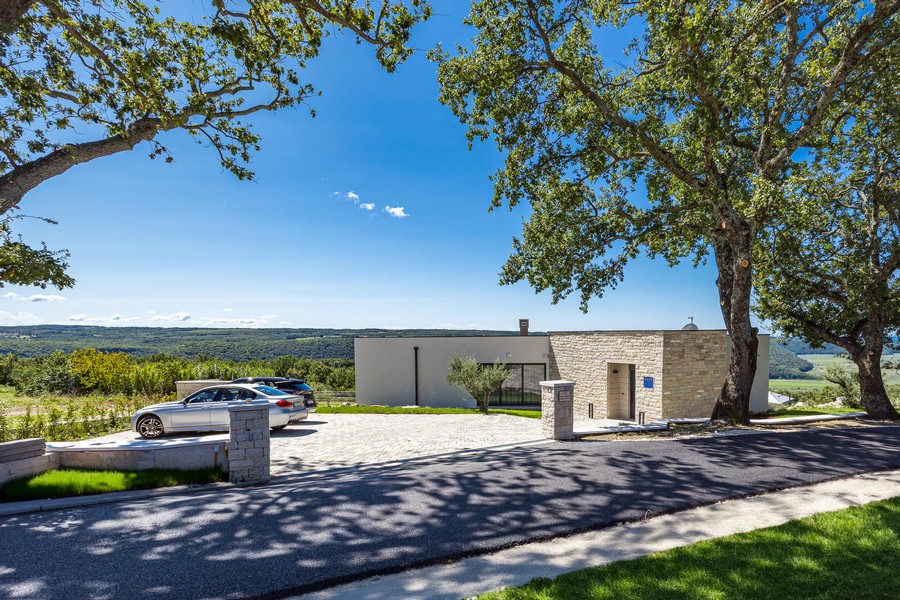 Allée avec places de stationnement et façade en pierre naturelle dans un cadre calme